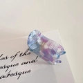 Detail view of acetate hair claw clip with blue marble pattern and gold Barrette La France text - Blue Purple White