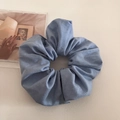 Macro detail of the blue denim scrunchie texture and soft pleated fabric folds - Light Blue
