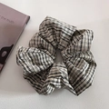 Detail showing oversized plaid scrunchie with white lace trim and cotton linen texture - Creamy Black