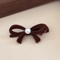 Detailed shot of brown velvet bow hair clip with a central pearl and alligator clip base - Pearl Bowknot / Brown