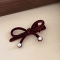 Detailed close-up of red velvet bow hair clip with elegant white pearl accents - Double Pearl Bow / Dark Coffee