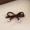 Detail of a brown velvet bow hair clip with elegant white pearls on a textured background - Double Pearl Bow / Light Coffee