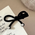 Detailed view of a black velvet bow hair clip with elegant pearls on a vintage card - Double Pearl Bow / Black