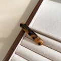 Detail of tortoise shell acetate hair clip with gold handmade text on wooden stand - Dark Tortoiseshell