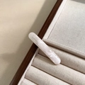 Detail of pink acetate oval hair clip with France Handmade lettering on fabric tray - Pearlescent White