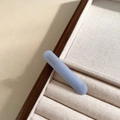 Macro view of light blue acetate hair clip with golden France Handmade lettering detail - Blue