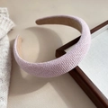 Close-up detail of light pink woven plaid headband with sponge padding and textured surface - Solid Pink
