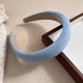 Close-up of light blue braided fabric headband with thick sponge and textured woven surface - Solid Blue