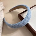 Detailed view of light blue woven plaid headband with sponge padding on wooden frame - Blue Plaid