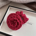 Macro shot of a deep rose red floral scrunchie with eyelet embroidery on a display tray - Rose Red