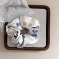 Detailed macro view of a silk hair scrunchie with blue ink landscape patterns - Blue Butterfly Chinese Style Scrunchie