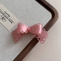 Close-up of pink acetate hair clip with bow shape and hollow heart pattern detail - 9# Pink Hair Clip