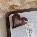 Detailed close-up of dark brown heart-shaped acetate hair claw clip with golden trim edge - 7# Coffee Color