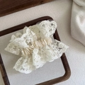 Detailed macro view of beige lace scrunchie with crochet floral texture and elastic band - Small Lace Scrunchie