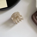 Detailed close-up of cream marble acetate hair claw with gold France Handmade lettering - Creamy Apricot Marble