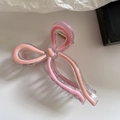 Detail of pink acrylic bow hair claw clip showing the spring and bicolored design - Light Pink Series