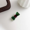 Detailed macro view of the bow-shaped acetate hair clip with gold France Handmade lettering - Green