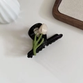 Elegant black acetate hair claw clip featuring a white tulip flower and green stem design - Black