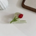 Detail view of a 3D tulip acetate hair claw clip with green translucent finish - Light Green
