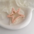Detail of light pink acetate star hair claw clip with golden metal spring mechanism - Pink