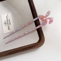 Pink and purple acetate U-shaped rabbit hair pin with gold eyelash detail on wood tray - Pale Blue