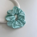 Minimalist mint green fabric scrunchie with brand label on a white ceramic plate - Mint Green