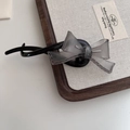 Detail of a grey translucent bow hair clip with hollow stitching on a black banana clip - 3# Black Grey