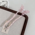 Detail of pink butterfly hair pin with marble texture and pearls in a wooden box - Cherry Pink
