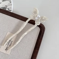 Detail of elegant butterfly hair fork with white marble texture and pearl accents - White