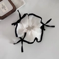 Elegant white mesh scrunchie with black trim and ribbon bows on light background - White