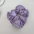 Elegant purple satin scrunchie with ruffled pleats and a silky texture hair accessory - Purple