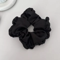 Elegant oversized black satin pleated scrunchie hair accessory on a minimalist background - Black