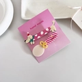 Detail of cute dachshund and spoon hair clips on a handmade pink display card - Christmas Dog Pair