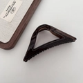 Detail view of transparent dark brown triangular hair claw clip on clean background - Triangle Style / Dark Amber Brown