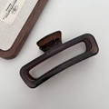 Detailed view of large dark brown translucent rectangular hair claw clip with glossy finish - Rectangle / Dark Amber Brown