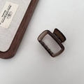 Detail of a large 13cm translucent amber acetate hair claw clip with sturdy metal spring - Small Square Style / Dark Amber Brown
