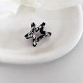 Close-up of a star-shaped acetate hair claw with monochrome cow print and gold spring - 5# Black and White Pattern