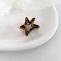 Macro view of star-shaped acetate hair claw with tortoise shell pattern and golden spring - 6# Dark Leopard