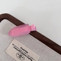 Close-up of matte pink resin hair clip with metal duckbill structure on linen tray - Frosted Duckbill Clip / Dark Pink