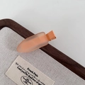 Close-up of matte apricot jelly hair clip on a wooden display tray for girls - Frosted Duckbill Clip / Orange