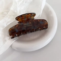 Detailed macro view of an amber tortoiseshell hair claw clip with blue marble accents - 7# Blue Coffee