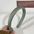 Detail of the gray green satin headband showing high-padded foam and sewing craftsmanship - Green