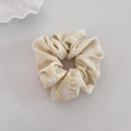 Detail showing yellow plaid scrunchie fabric with intricate bow embroidery and soft texture - Lime Yellow