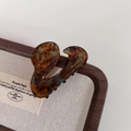 Detail showing tortoiseshell pattern hair claw clip with gold Barrette La France lettering - Blue Coffee