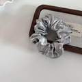 Metallic silver scrunchie with pleated texture on a wooden tray with a minimalist design - Silver Small