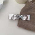 Zilveren lederen haarstrik met roosdetail op een minimalistische witte achtergrond - Zilver
