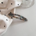 Macro detail of oval marble acetate hair clip with silver stainless steel spring metal base - Grey Blue Amber
