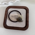 Detailed view of an amber-toned heart-shaped polished stone on a brown elastic hair tie - 1# Dark Green Heart