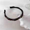 Detail of braided velvet headband with grey rhinestones on a decorative white shell tray - Dark Coffee