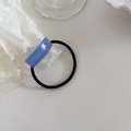 Close-up of blue acrylic geometric charm on black high-elasticity hair tie for ponytails - Blue Stripe